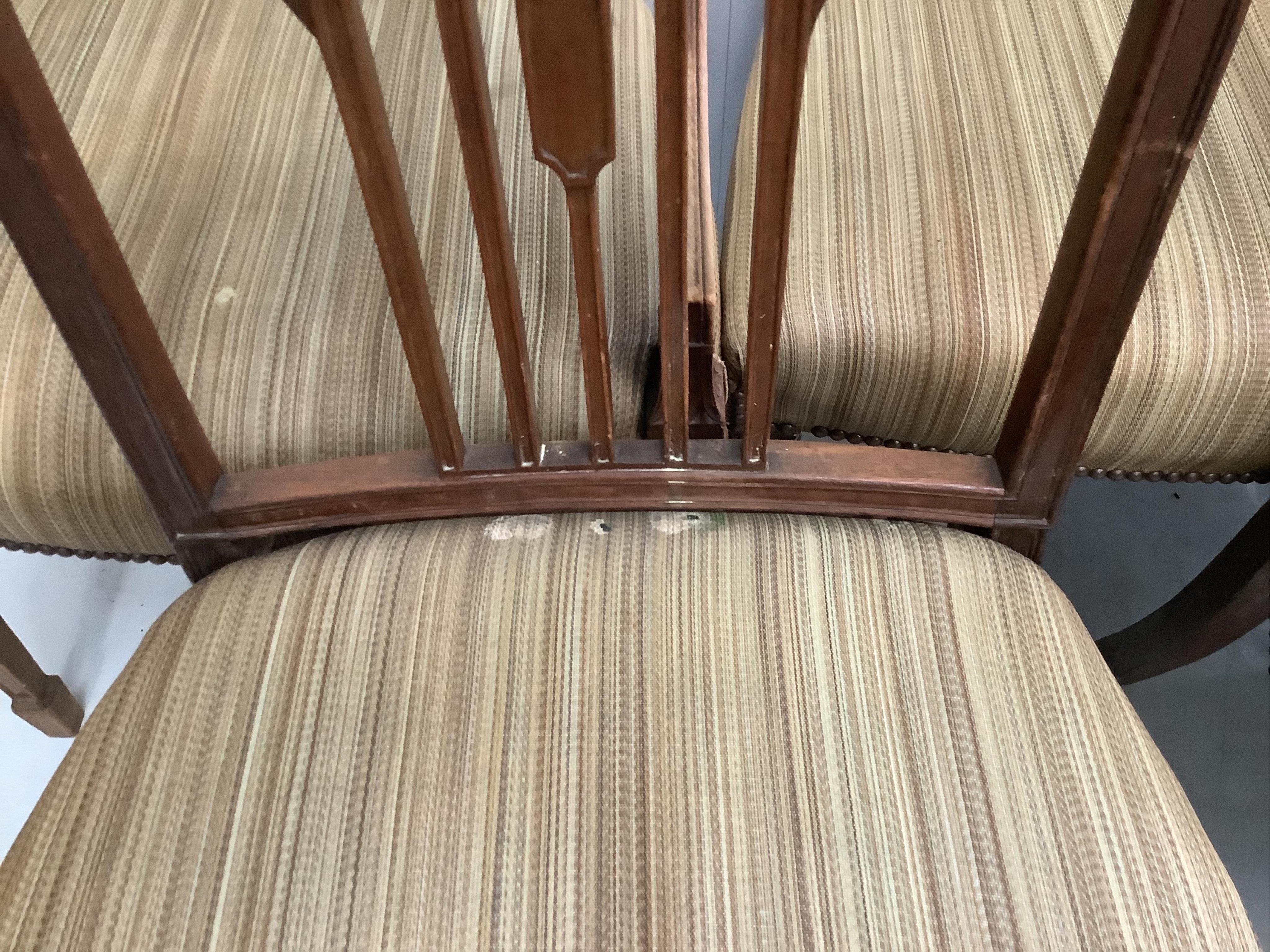 A set of seven Sheraton style mahogany dining chairs, two with arms, width 56cm, depth 50cm, height 91cm. Condition - fair